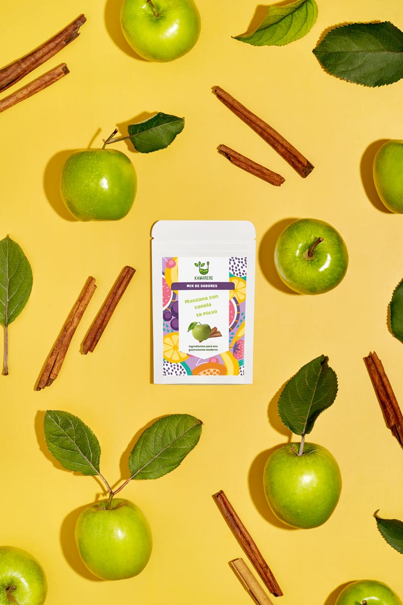 Kamarere Apple Cinnamon: A captivating flat lay photograph featuring a white packaging filled with a finely powdered blend of fresh seasonal ingredients. Surrounding the packaging, you'll find  juicy apples and fragrant cinnamon. This exquisite studio product photography showcases the essence of the Kamarere food brand.