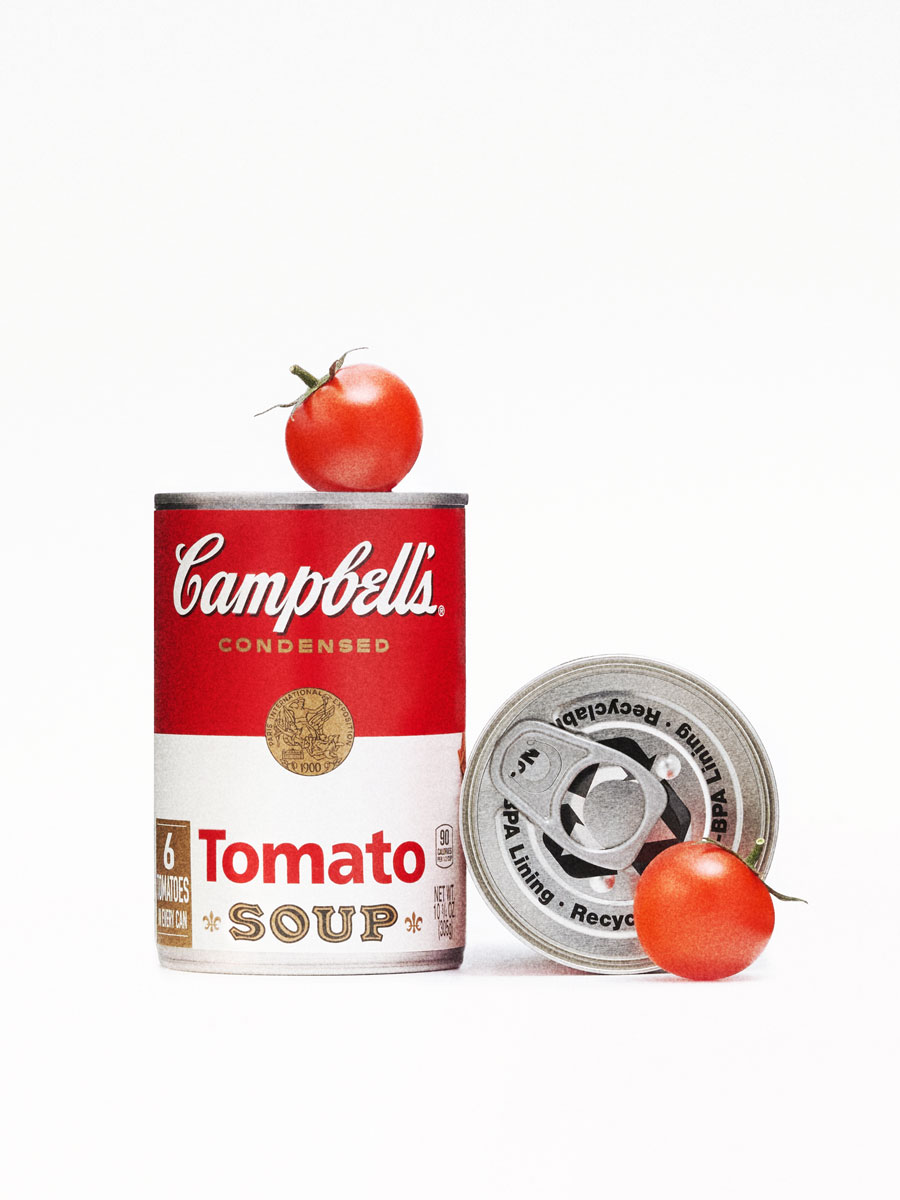 A minimalist studio shot showcasing a Campbell’s Tomato Soup can paired with fresh tomatoes. This clean, graphic composition highlights both the iconic packaging and the natural ingredients behind it.
