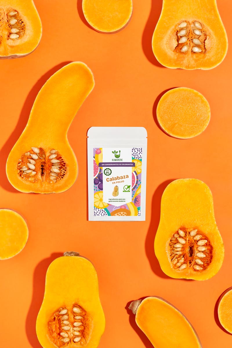 Captivating flat lay photograph featuring a white packaging filled with a finely powdered blend of fresh seasonal ingredients. Surrounding the packaging, you'll find juicy pumpkin. This exquisite studio product photography showcases the essence of the Kamarere food brand.